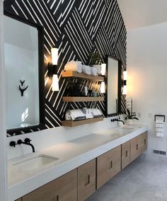 a bathroom with two sinks and a large mirror on the wall next to each other