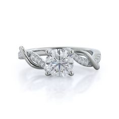 a white gold engagement ring with a twisted band and a round diamond center stone on the side