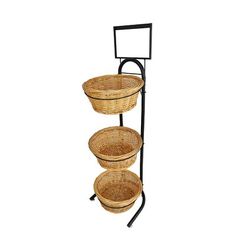 three wicker baskets are stacked on a metal stand with two black stands holding them