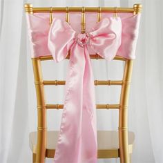 a chair with a pink sash tied to it