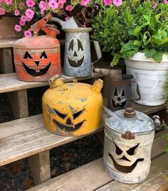 some pumpkins and jack - o'- lanterns are sitting on the wooden steps