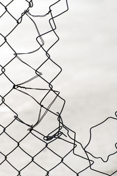 a black and white photo of a wire fence