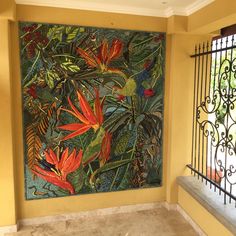 a painting hanging on the wall next to a window with iron bars in front of it