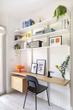 a desk with a chair and some pictures on it