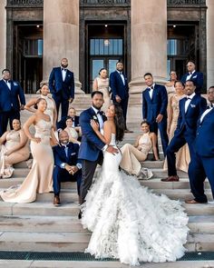 a group of people in formal wear posing on steps