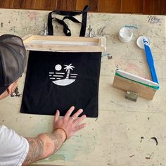 a man sitting at a table with a bag on it