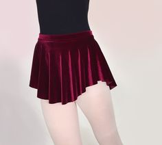 This soft and flowy ballet skirt is a beautiful and rich wine red. Our simple elegant style and flattering hemline looks great on everyone. -4 way stretch velvet -Rich maroon / dark red / wine / merlot / burgundy -Luxurious and soft with a pretty drape Dance teachers love this skirt because it is short enough to show correct technique. Youll love it for the graceful, flowing shape that shows off your dancers legs! All Royall Dancewear skirts are made of quality 4-way stretch fabrics. Weve... Ballet Leotards Yumiko, Disney Hairstyles, Ballet Fits, Red Velvet Skirt, Dancer Legs, Ballet Skirts, Simple Elegant Style, Pinewood Derby Cars, Ballet Leotards