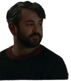 a man with a beard is looking at something in the distance while wearing a sweater