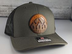 Mountain wood on leather patch hat.  Through a painstaking process we have learned how to inlay wood and leather for a one-of-a-kind style hat. Impress your friends with the mountain landscape patch hat.  As always made on high quality snapback hat. -Product Care instructions-                      Hand wash only.   -Shipping and Production-                     We produce each item as made to order.  Currently our production and shipping time is 1-3 business days.  We also can ship            pri Brown Hats With Leather Patch For Outdoor Activities, Leather Hat Pattern, Womans Hat, Leather Patch Hat, Patch Hat, Unique Hats, Hat Patches, Man Hat, Leather Hats