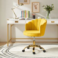 a yellow chair sits in front of a white desk with books and flowers on it