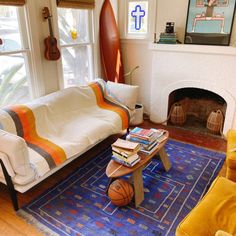 a living room filled with furniture and a basketball on top of a table next to a fire place