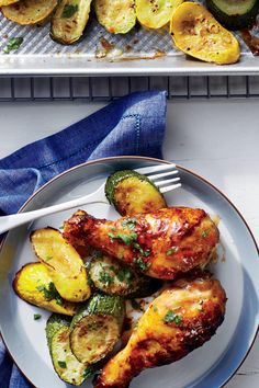 two pans filled with chicken on top of a table next to a plate of salad