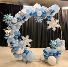 a balloon arch decorated with snowflakes and stars