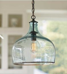 a glass pendant light hanging from a ceiling in a kitchen or dining room with the words globe glass pendant light above it