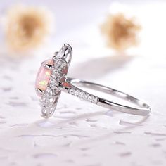 This is an pink opal engagement ring white gold. The stones are Opal and VVS man made cz diamond. The center opal is about 6x8mm oval Cut. The stones can be replace with other gemstones.For example,if you don't like the CZ accent,you can ask me replace it with tourmaline,aquamarine,diamond,emerald,sapphire... For custom making jewelry,it can be made in 2 different metal. 1,Solid gold,including 14/18k white/rose/yellow gold. 2,925 sterling silver with white/yellow/rose gold plated. High quality w Pink Opal Ring With Accent Stones As Gift, Pink Opal Gemstone Ring For Anniversary, Pink Opal Ring In Sterling Silver For Anniversary, Pink Opal Ring For Anniversary, Fine Jewelry, Pink Sterling Silver Opal Ring For Anniversary, Pink Opal Ring For Anniversary, Elegant Pink Opal Ring, Elegant Pink Opal Ring In Sterling Silver, Elegant Silver Rings With Pink Opal