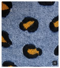 blue and yellow fabric with black circles on it