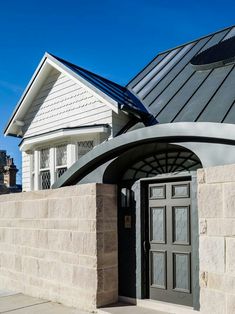 the front entrance to a house with an arched door