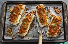 baked fish on a baking sheet with a spatula