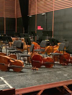 several cellos are lined up on the stage