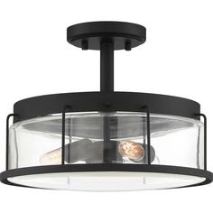 a semi flush ceiling light fixture with clear glass panels and black metal frame, on an isolated white background