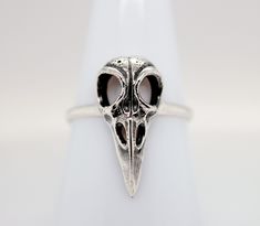 Sterling Silver Raven Skull Ring. This sterling silver bird skull ring features a hollow 3D design with oxidized details. This ring looks great on its own or as part of an on-trend stacked look. Finish may very slightly from pictures.  Each order comes with a polishing cloth, anti-tarnish strip, jewelry/candle care instructions and a custom jewelry box. PLUS  a goodie bag with stickers or book mark, wax melts, tumbled or raw gemstone and a coupon code for your next order * Materials: .925 Sterli Custom Jewelry Box, Raven Skull, Bird Skull, Jewelry Candles, Ring Antique, Gem Ring, Skull Ring, Skull Design, Raw Gemstones