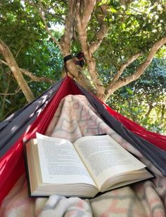 an open book is laying in a hammock