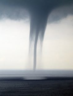 a large tornado is coming out of the sky