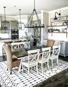 a dining room table with chairs and vases on it