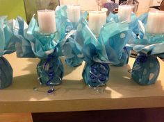 some blue and white vases with candles in them