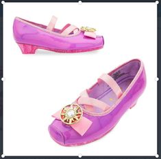 Sparkling, ''sugared glitter'' uppers Metallic faux leather bow and detailing on strap and heel Strap features self-stick fabric fastening Purple satin cord detailing Satin lining and footbed Golden Corona emblem with faceted gem in the center Textured non-slip soles 1/2'' low heel Part of our Rapunzel Costume Collection for Kids Inspired by Tangled: The Series   All man-made materials Imported Crochet Baby Halloween, Bell Costume, Rapunzel Costume, Makeup Kit For Kids, Girls High Heels, Princess Toys, Costume For Kids, Disney Rapunzel, Sparkle Shoes