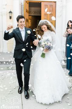 a newly married couple walking through confetti