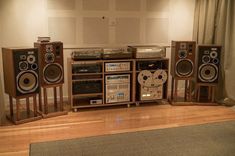 an array of musical equipment on display in a room with wood floors and walls,