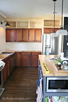 a kitchen with wooden cabinets and stainless steel appliances