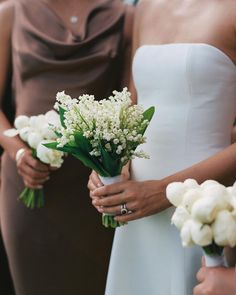 the bridesmaids are holding bouquets of white flowers