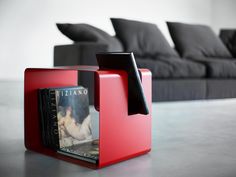 a red box sitting on top of a table next to a couch