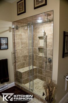 a bathroom with a walk in shower next to a toilet