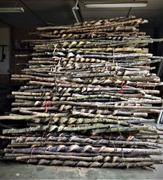 a large pile of logs sitting on top of a floor