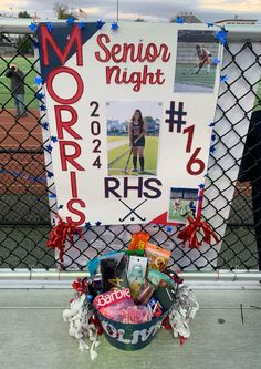 a sign that says senior night next to a basket full of candy and candies