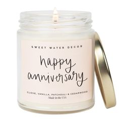 happy anniversary candle in a glass jar with a gold lid and the words, sweet water decor