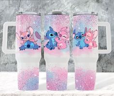 two pink and blue tumblers with cartoon characters on them