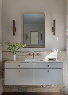 a bathroom with two sinks and a large mirror