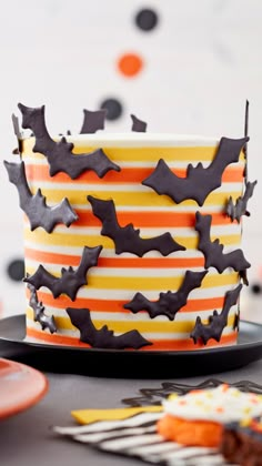 a decorated halloween cake with bats on it