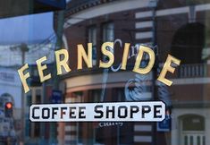 there is a sign that says fernside coffee shoppe on the glass door window