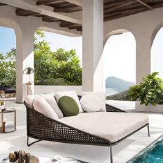 an outdoor living area with pool and patio furniture