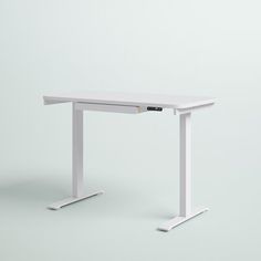 a white computer desk sitting on top of a table