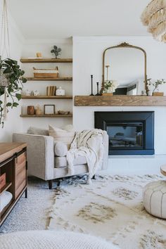 a living room filled with furniture and a fire place in front of a mirror on the wall