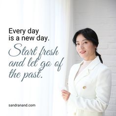 a woman standing in front of a white brick wall with the words start fresh and let go of the past