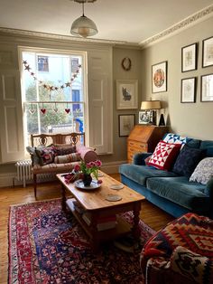 a living room with two couches and a coffee table in front of a window