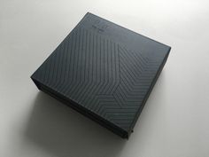 a black book sitting on top of a white table