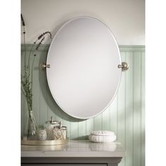 a bathroom mirror sitting on top of a counter